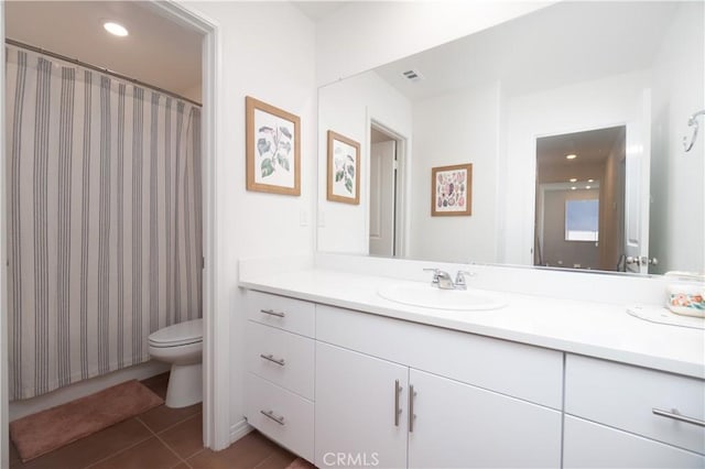 bathroom featuring visible vents, toilet, vanity, and tile patterned floors