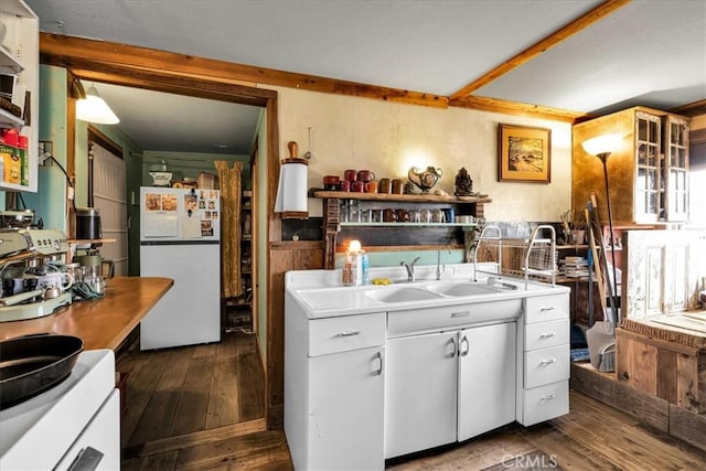 kitchen featuring white cabinetry, freestanding refrigerator, dark wood-type flooring, and light countertops