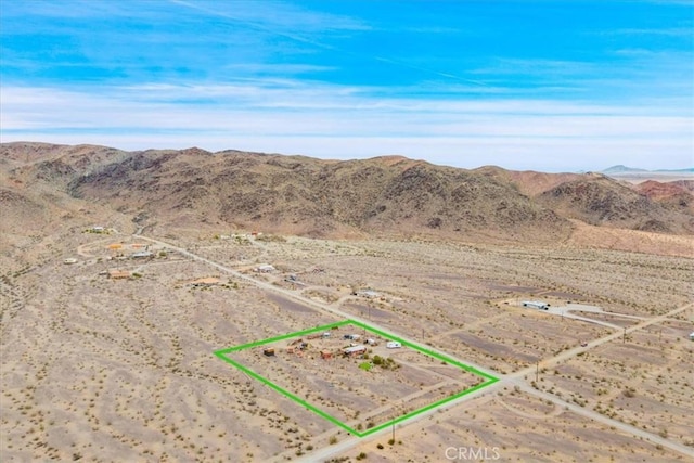 birds eye view of property featuring a rural view, a mountain view, and a desert view