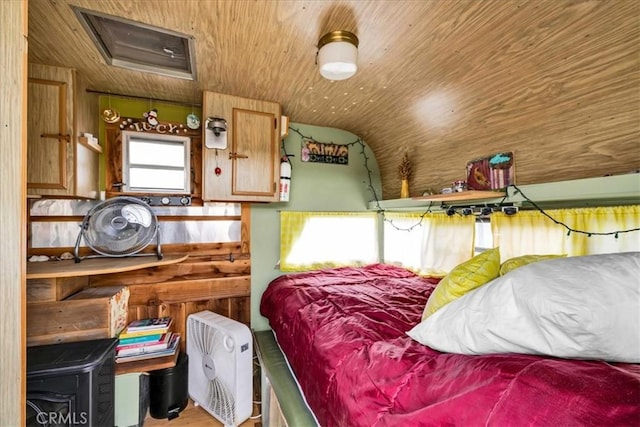 bedroom with attic access, wooden ceiling, and vaulted ceiling