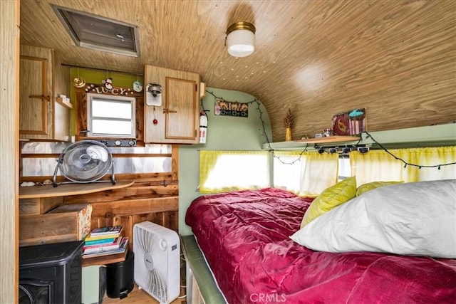 bedroom with wooden ceiling, attic access, wood finished floors, and lofted ceiling