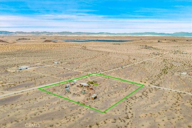 aerial view with a mountain view, a rural view, and view of desert