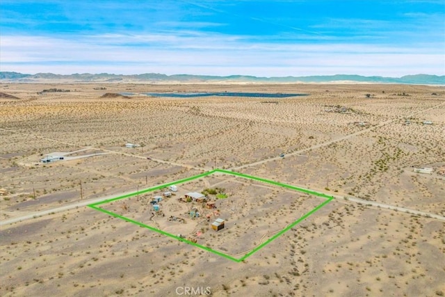 aerial view featuring a mountain view, a rural view, and view of desert