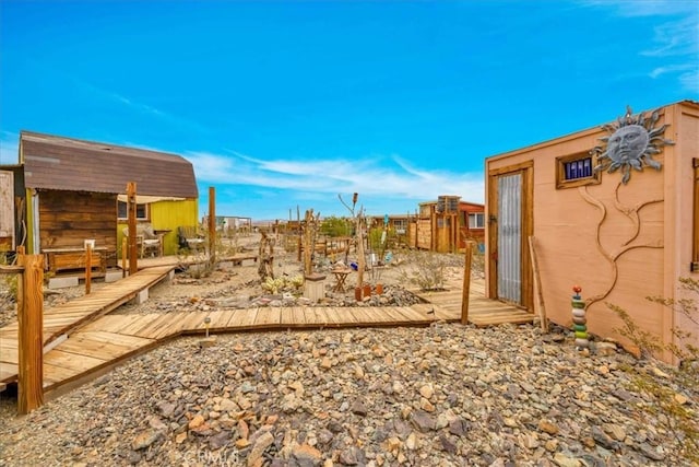 view of yard with a wooden deck and an outdoor structure