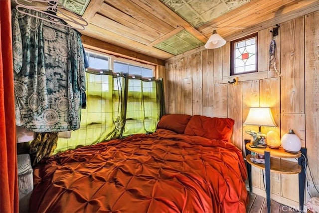 bedroom with wooden walls and wooden ceiling