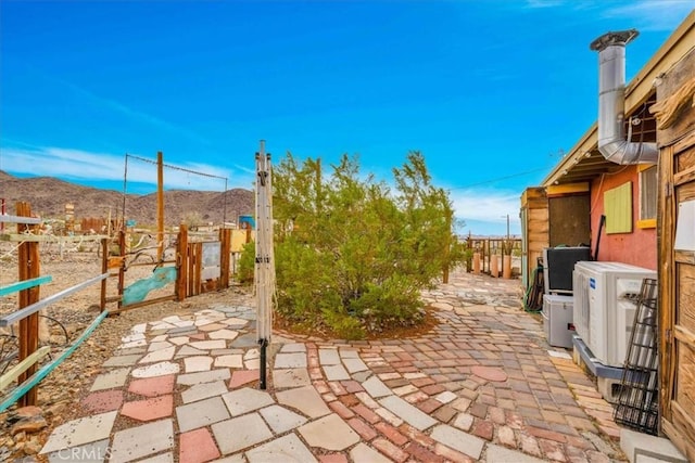 view of patio / terrace featuring a mountain view and fence