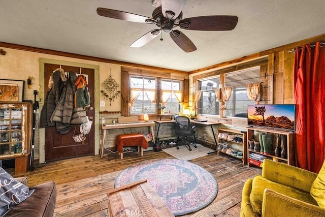 office with wood-type flooring, a textured ceiling, and a ceiling fan