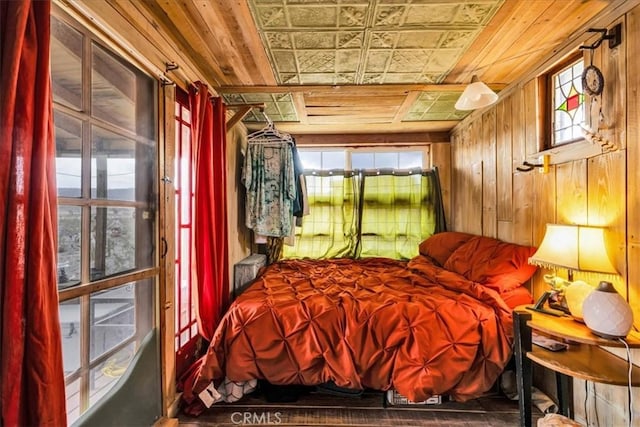 bedroom with wooden walls and wooden ceiling