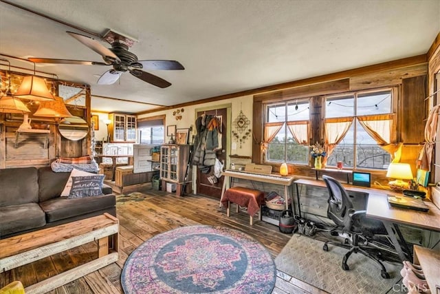 interior space with wood-type flooring and ceiling fan