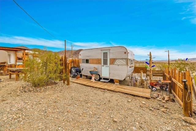 back of property with an outdoor structure and fence