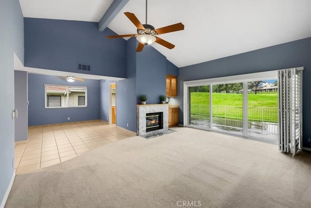 unfurnished living room with tile patterned floors, visible vents, ceiling fan, and carpet floors