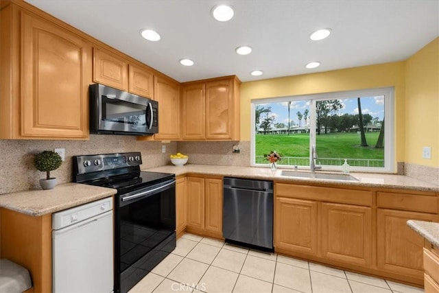 kitchen with stainless steel microwave, black range with electric stovetop, dishwasher, white dishwasher, and a sink