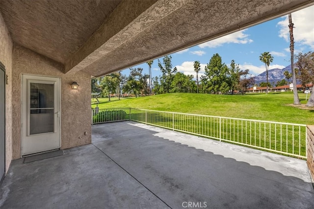 view of patio / terrace featuring a mountain view and fence