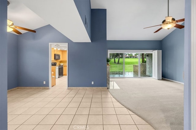 interior space featuring tile patterned flooring, carpet flooring, a ceiling fan, and high vaulted ceiling