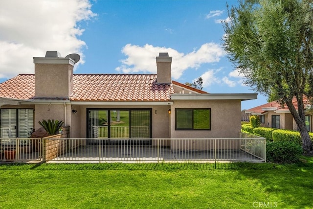 back of house featuring stucco siding, a lawn, and a chimney