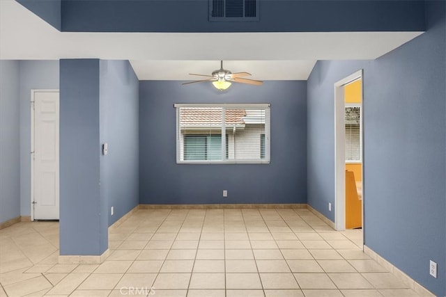 spare room with light tile patterned floors, visible vents, baseboards, and a ceiling fan