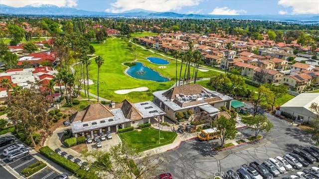 birds eye view of property featuring view of golf course, a residential view, and a water and mountain view