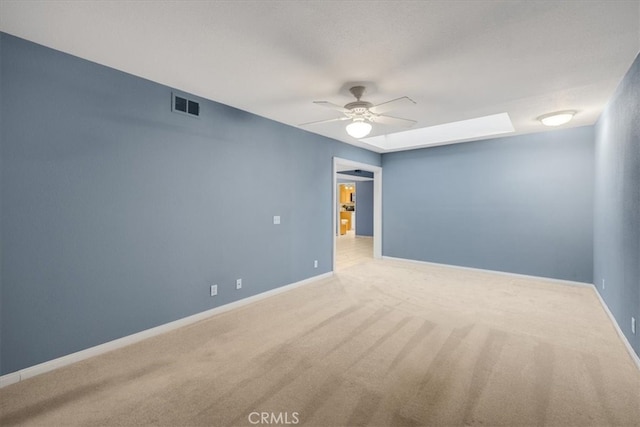 unfurnished room with visible vents, baseboards, carpet flooring, and a ceiling fan