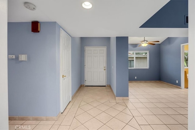 entryway featuring light tile patterned floors, baseboards, and a wealth of natural light