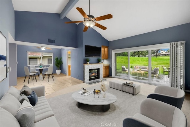 tiled living room featuring visible vents, beamed ceiling, high vaulted ceiling, a fireplace, and ceiling fan