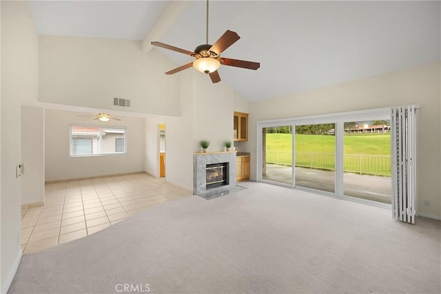 unfurnished living room featuring tile patterned flooring, carpet floors, high vaulted ceiling, a ceiling fan, and visible vents