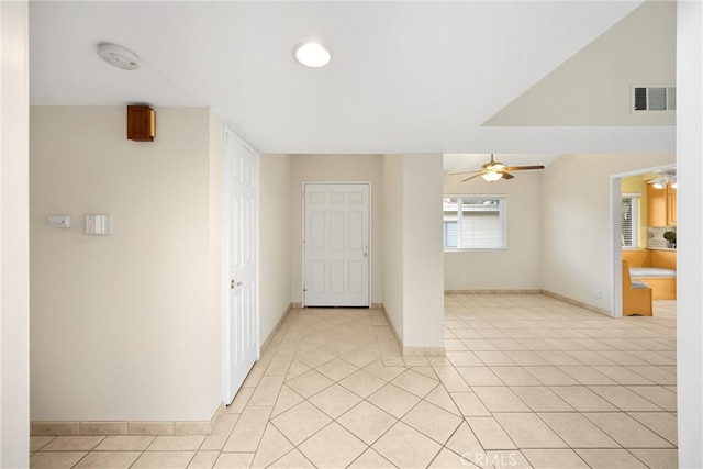 spare room with a ceiling fan, baseboards, visible vents, and light tile patterned floors