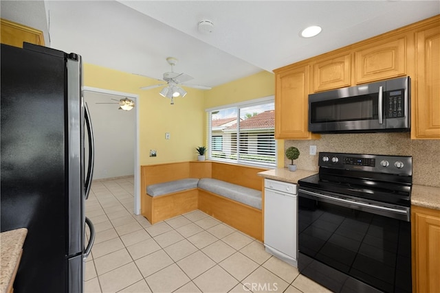 kitchen with ceiling fan, appliances with stainless steel finishes, tasteful backsplash, light tile patterned floors, and light countertops
