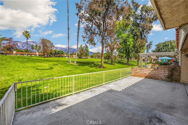 view of patio with a mountain view and a pergola