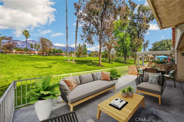 view of patio featuring an outdoor living space, outdoor dining area, a mountain view, and a pergola