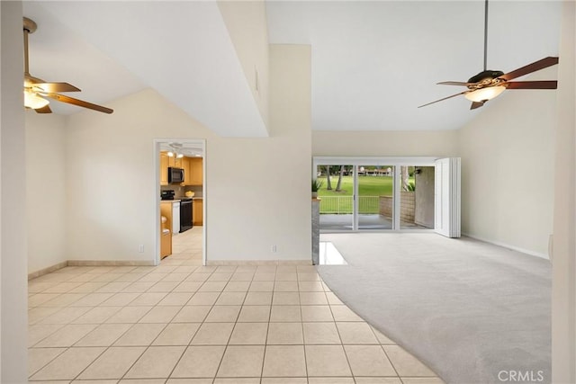 interior space with high vaulted ceiling, ceiling fan, baseboards, and light tile patterned flooring
