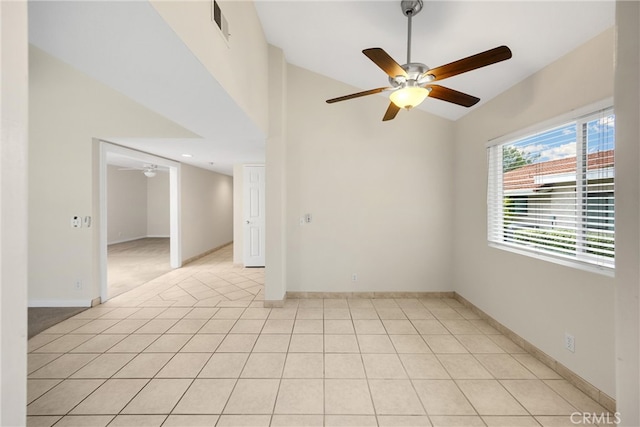 spare room featuring light tile patterned flooring, high vaulted ceiling, a ceiling fan, baseboards, and visible vents