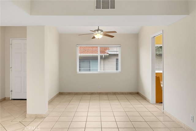 unfurnished room featuring visible vents, baseboards, ceiling fan, and light tile patterned floors