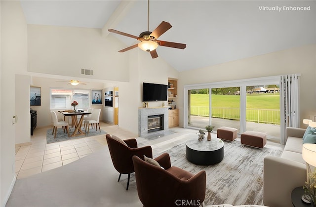 living area featuring visible vents, light tile patterned flooring, high vaulted ceiling, a ceiling fan, and a premium fireplace