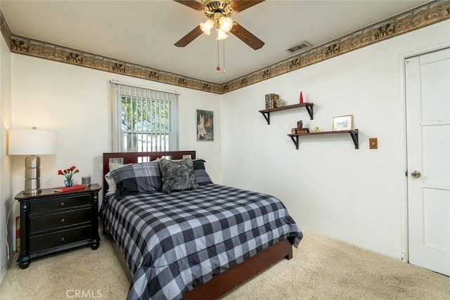 bedroom featuring light carpet, visible vents, and ceiling fan