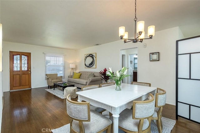 dining room featuring a notable chandelier and dark wood-style flooring