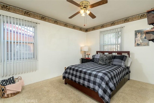 bedroom with ceiling fan and carpet flooring