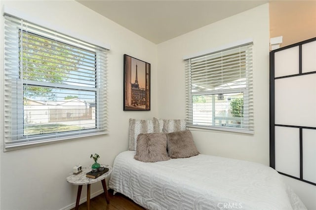 bedroom with wood finished floors and baseboards