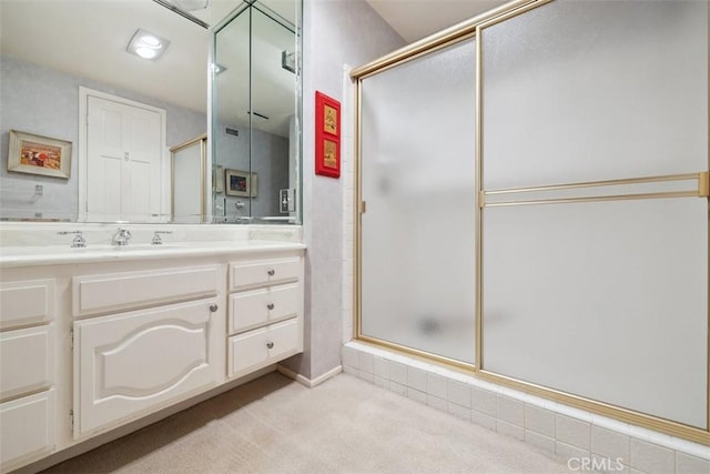 bathroom featuring a stall shower and vanity