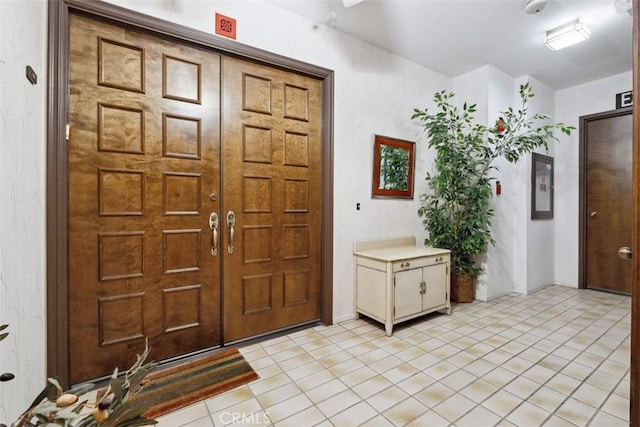 foyer entrance with light tile patterned flooring