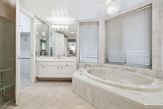 bathroom with vanity and a garden tub