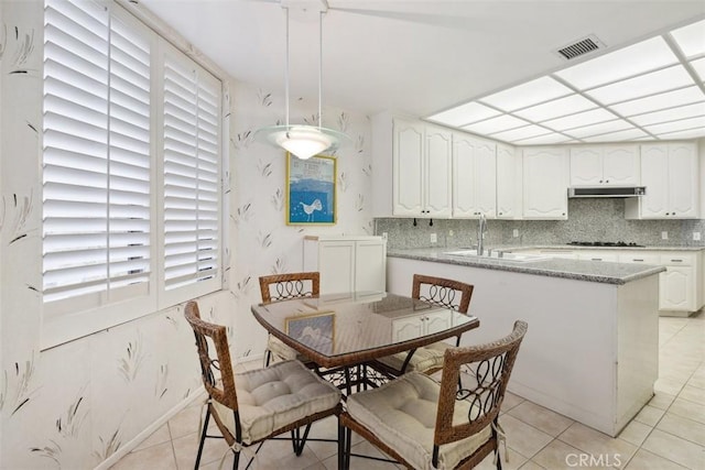 dining space featuring light tile patterned flooring and visible vents