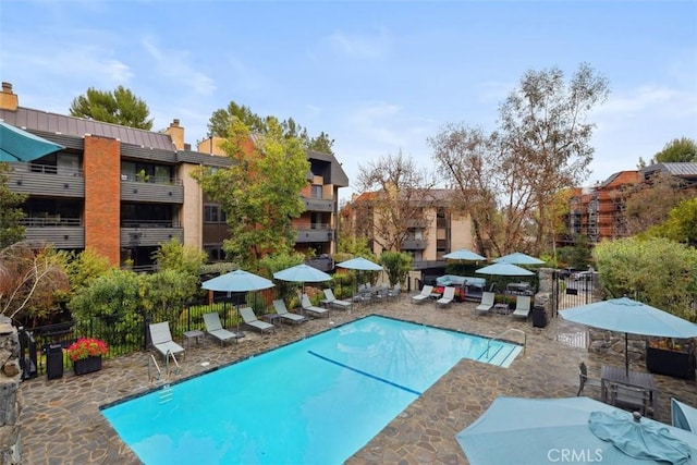 pool featuring a patio and fence