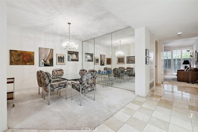 dining space with an inviting chandelier and a textured ceiling