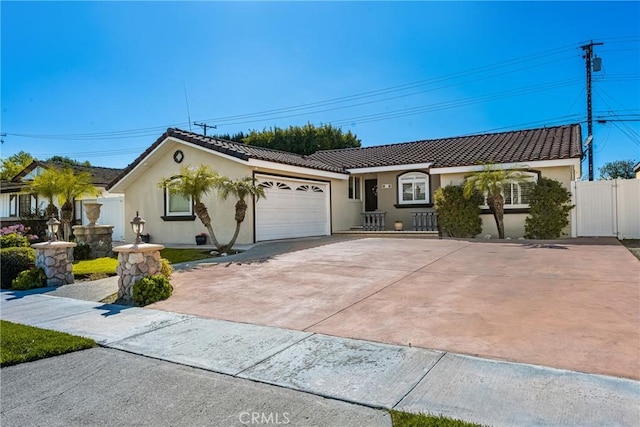 ranch-style house featuring stucco siding, fence, driveway, and a tiled roof