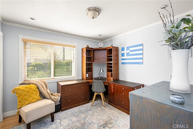 office area featuring light wood finished floors, baseboards, and ornamental molding