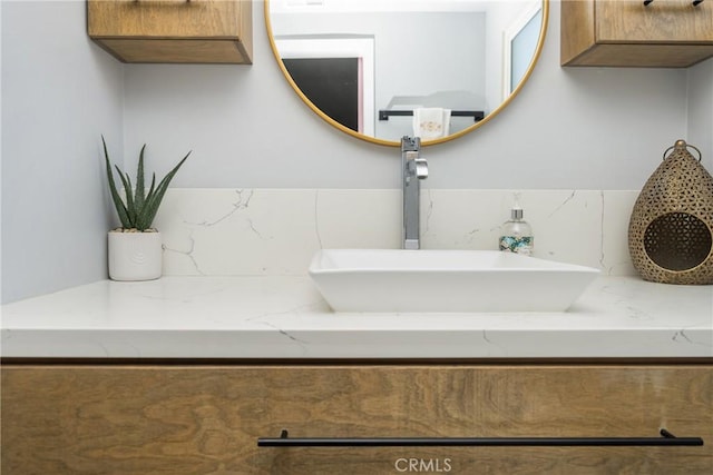 interior details featuring backsplash and vanity