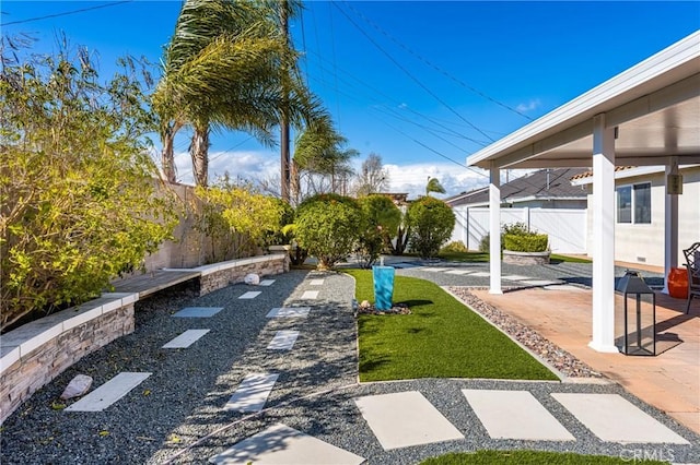 view of yard with a patio and fence