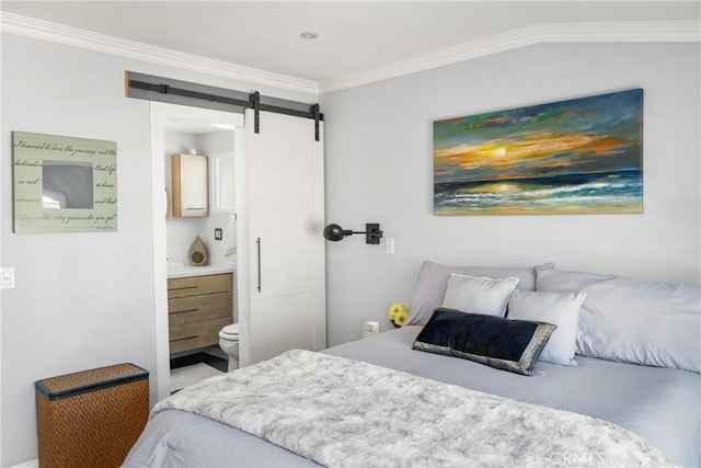 bedroom with ensuite bath, crown molding, and a barn door