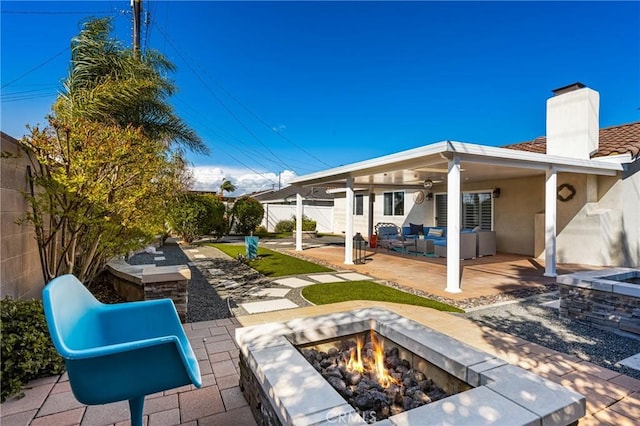 view of patio / terrace featuring an outdoor living space with a fire pit and a fenced backyard