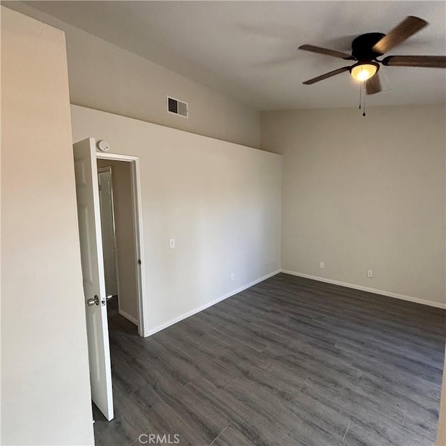 unfurnished room featuring visible vents, baseboards, a ceiling fan, and dark wood-style flooring